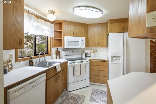16354 SW 130th Ter Unit 76, King City, OR 97224 - kitchen with a sink, open shelves, white appliances, and light countertops