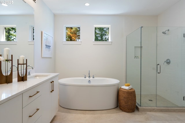 15708 NW Raywood Ln Unit L 24, Portland, OR 97229 - full bath featuring plenty of natural light, a shower stall, double vanity, a freestanding tub, and recessed lighting