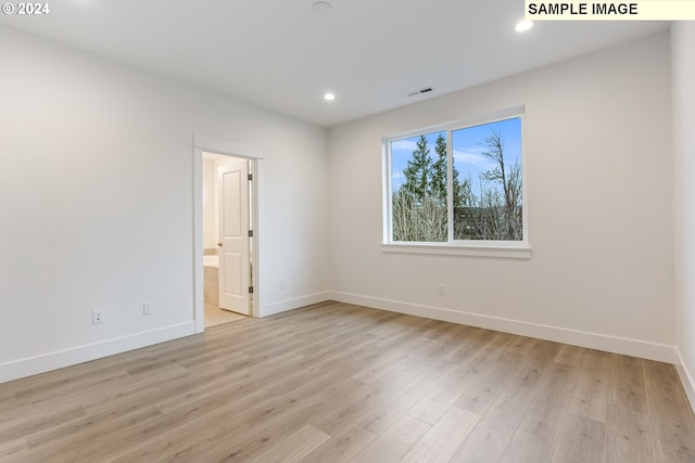 empty room with light hardwood / wood-style flooring