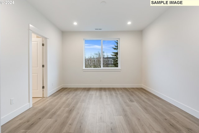 spare room with light wood-type flooring