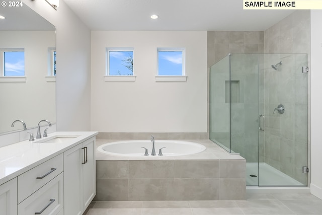 bathroom with tile patterned flooring, vanity, and shower with separate bathtub