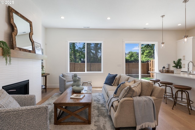 15708 NW Raywood Ln Unit L 24, Portland, OR 97229 - living area with plenty of natural light, light wood-style flooring, recessed lighting, and a fireplace