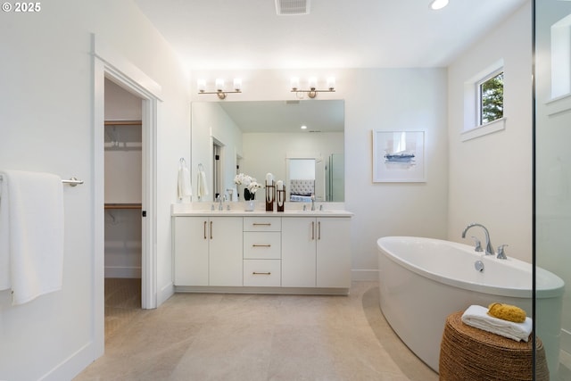 15708 NW Raywood Ln Unit L 24, Portland, OR 97229 - bathroom featuring double vanity, a soaking tub, a spacious closet, an enclosed shower, and baseboards
