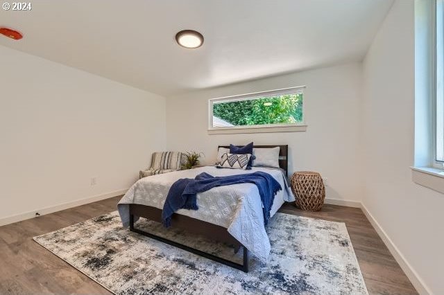 bedroom with dark wood-type flooring