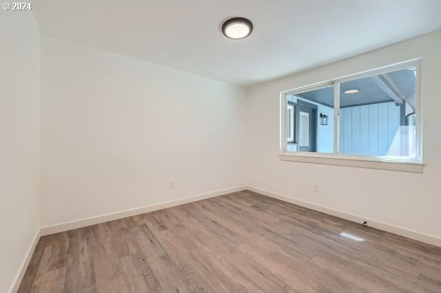 empty room with hardwood / wood-style flooring