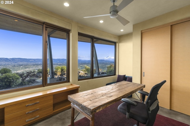 office space featuring a mountain view and ceiling fan