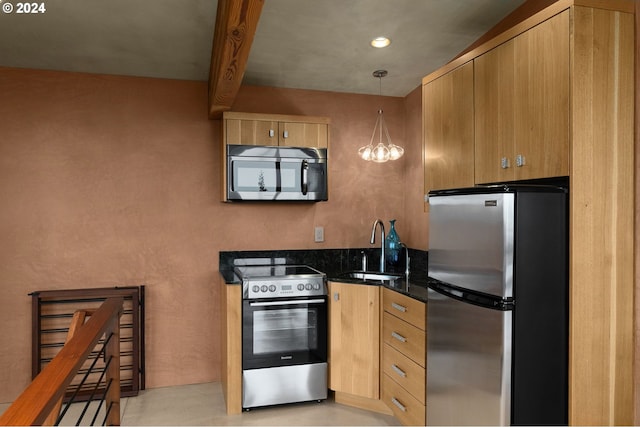 kitchen featuring hanging light fixtures, sink, dark stone countertops, appliances with stainless steel finishes, and beamed ceiling