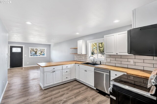 kitchen with light hardwood / wood-style flooring, white cabinetry, and dishwasher