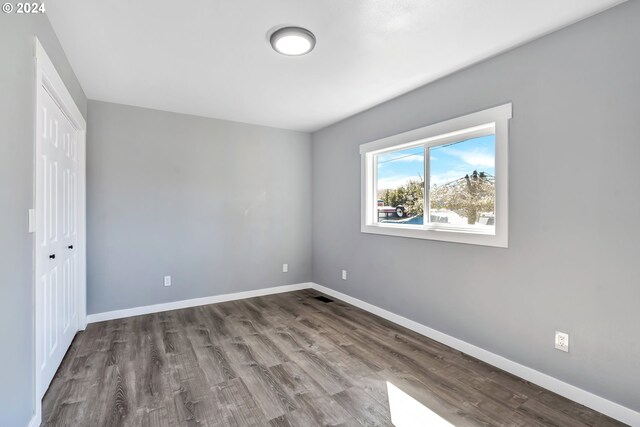 spare room featuring dark hardwood / wood-style floors