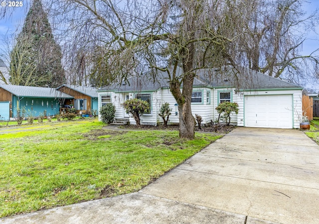 ranch-style house featuring a garage and a front yard