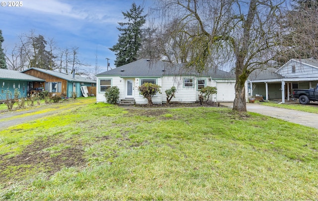 ranch-style home with a garage and a front lawn