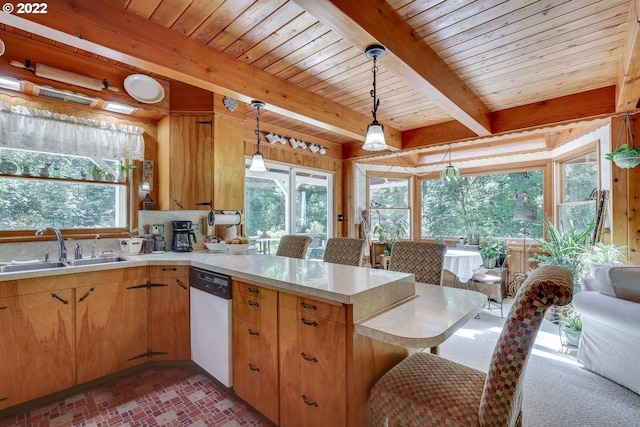 kitchen with beamed ceiling, dishwasher, pendant lighting, and kitchen peninsula