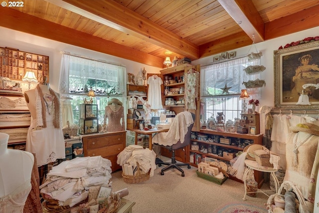 sitting room featuring carpet, beam ceiling, and wooden ceiling