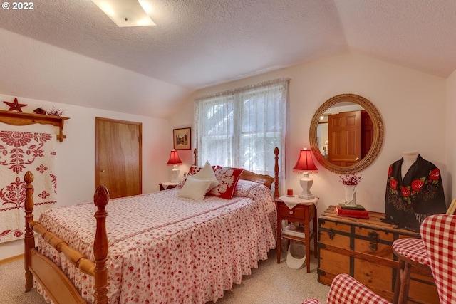 carpeted bedroom with a textured ceiling and lofted ceiling