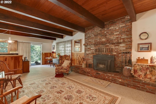 living room with dark colored carpet, beamed ceiling, a wood stove, a fireplace, and wooden ceiling