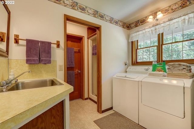 washroom featuring separate washer and dryer and sink