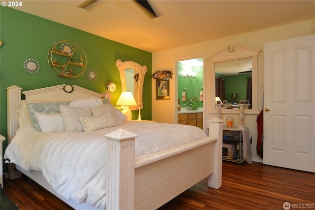 bedroom featuring connected bathroom, dark hardwood / wood-style floors, and ceiling fan