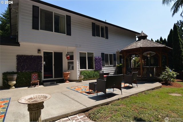 back of house with a gazebo and a patio area