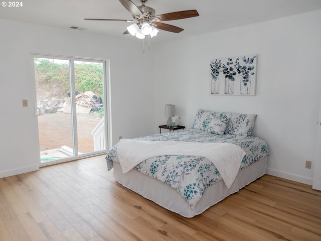 bedroom featuring hardwood / wood-style flooring, access to outside, and ceiling fan