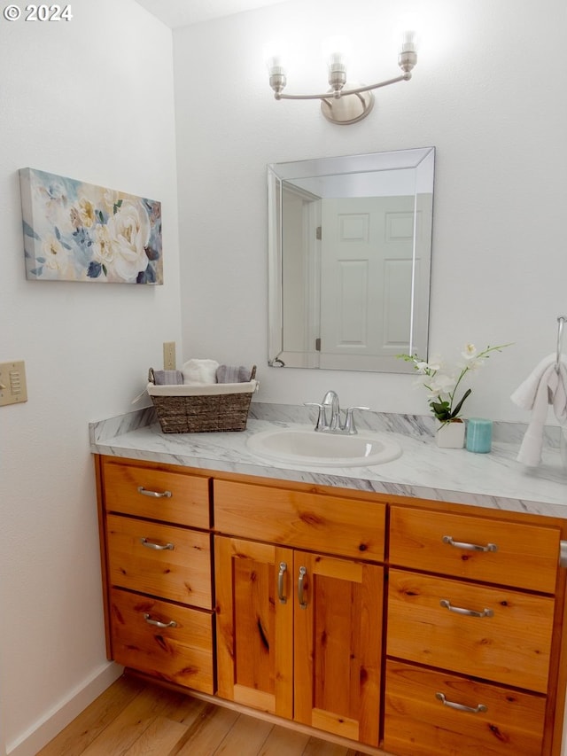 bathroom with hardwood / wood-style flooring and vanity