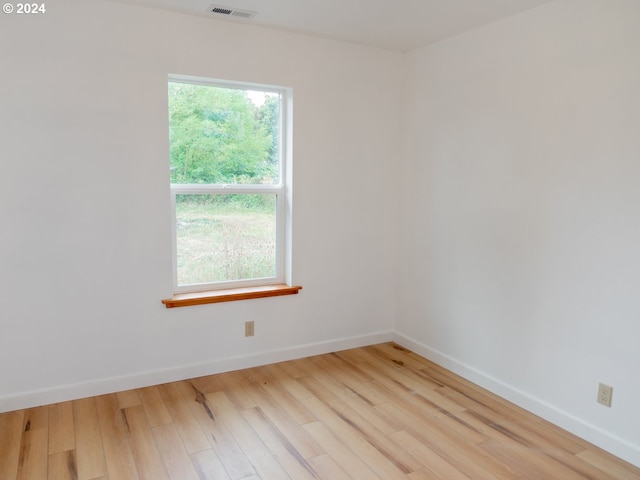 unfurnished room with light wood-type flooring