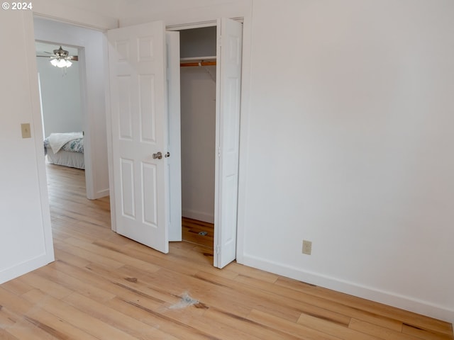 unfurnished bedroom featuring light wood-type flooring and a closet