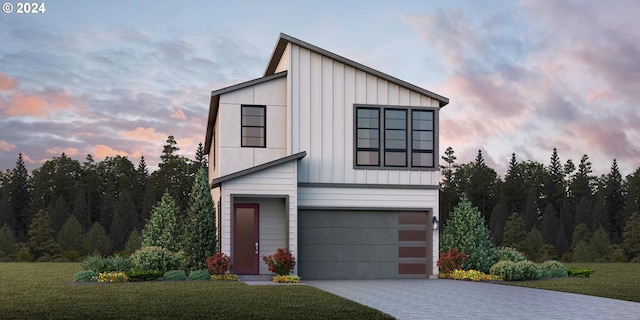 view of front facade with a garage and a yard