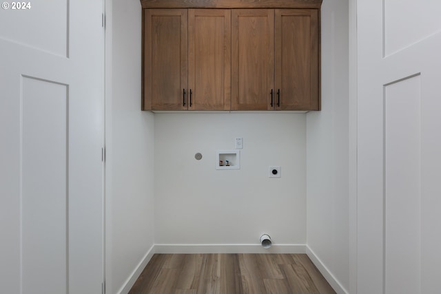laundry room featuring hookup for an electric dryer, baseboards, dark wood-style floors, cabinet space, and washer hookup