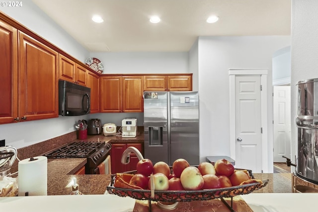 kitchen with stainless steel appliances and light hardwood / wood-style flooring