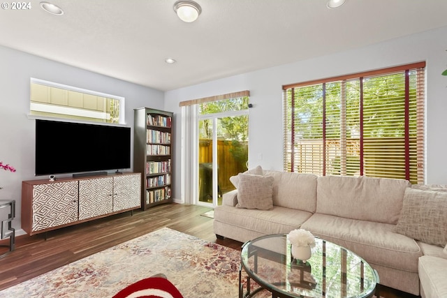 living room with recessed lighting, baseboards, and wood finished floors