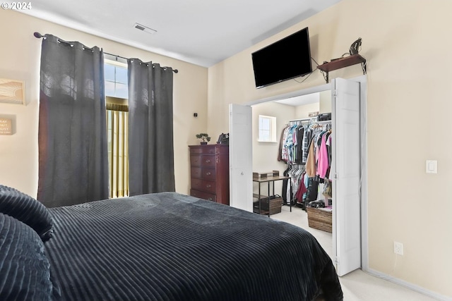 bedroom with carpet, visible vents, and a closet