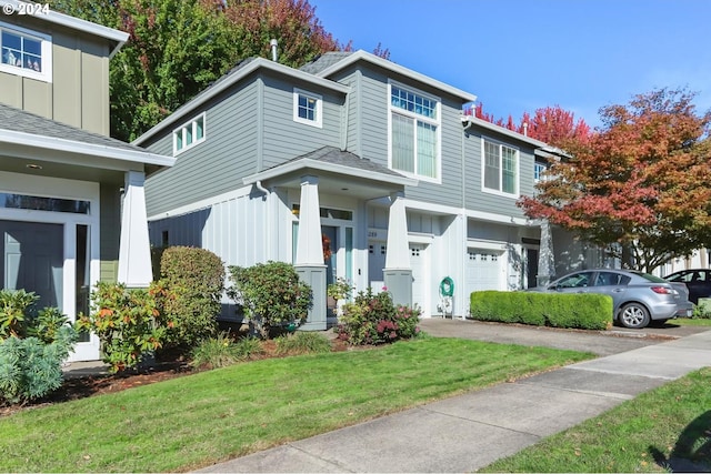 view of front of property with a front yard and a garage