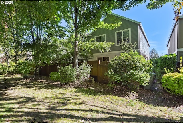 view of home's exterior featuring fence
