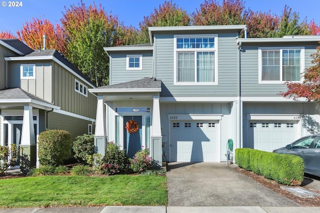 view of front of property with a front yard and a garage