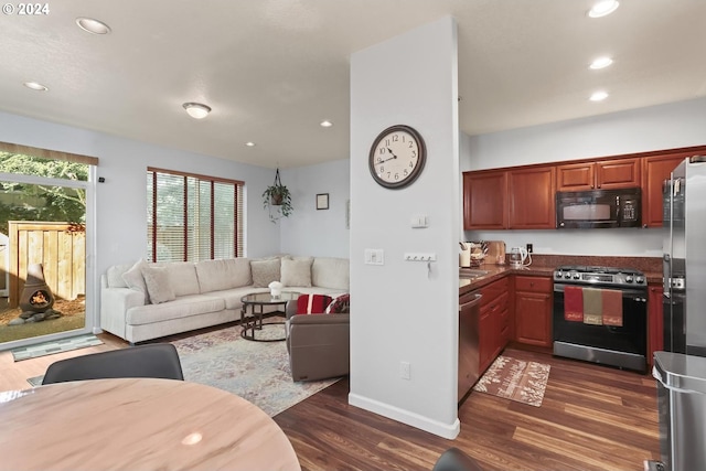 kitchen featuring recessed lighting, open floor plan, dark wood-style flooring, and appliances with stainless steel finishes
