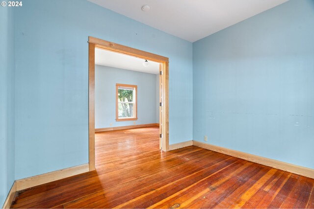 unfurnished room featuring hardwood / wood-style flooring