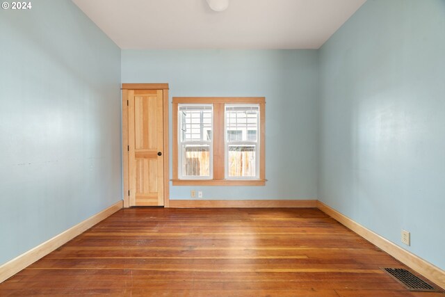 unfurnished room featuring hardwood / wood-style flooring