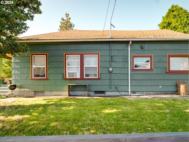 view of property exterior with a lawn