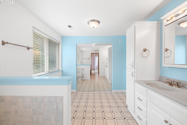 bathroom with vanity and toilet