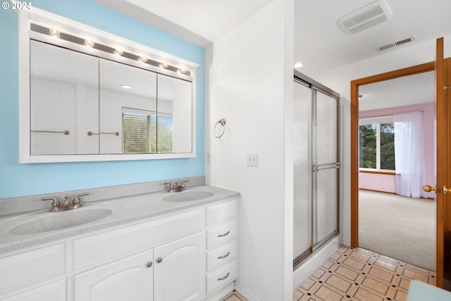 bathroom with vanity and an enclosed shower