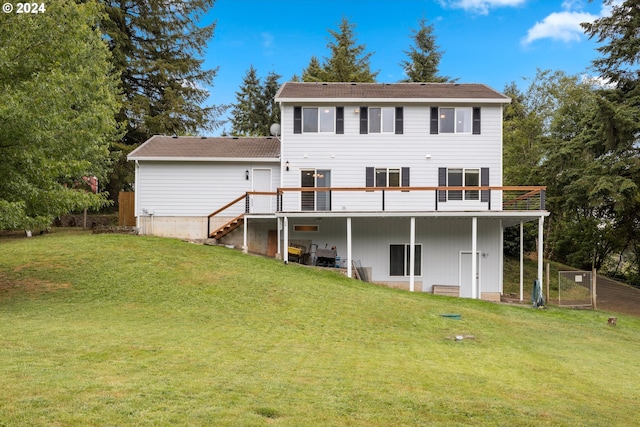 rear view of house with a yard and a wooden deck