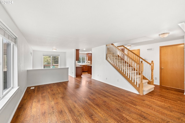 unfurnished living room with dark hardwood / wood-style flooring