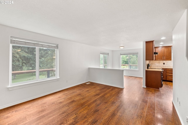 unfurnished room featuring dark hardwood / wood-style floors and a textured ceiling