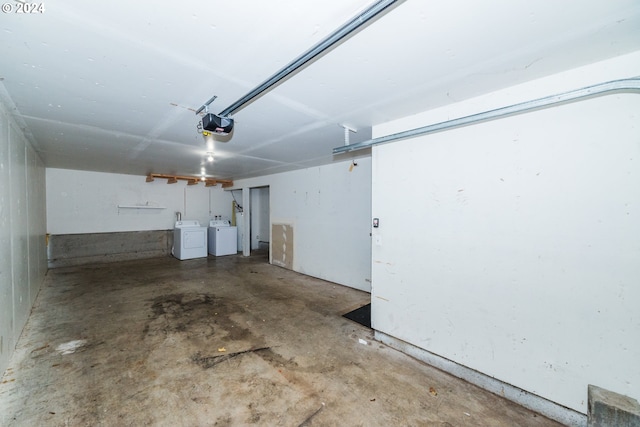 garage with washer and clothes dryer and a garage door opener