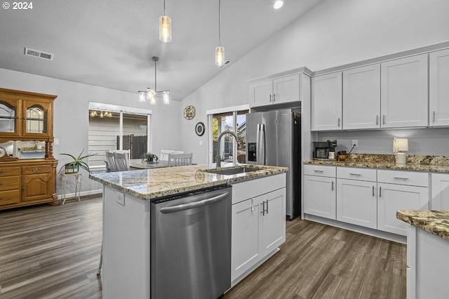 kitchen featuring white cabinets, a kitchen island with sink, high vaulted ceiling, decorative light fixtures, and stainless steel appliances