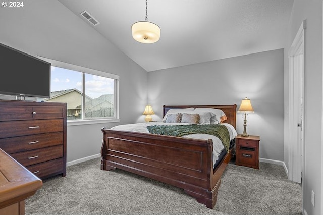 bedroom with baseboards, vaulted ceiling, visible vents, and carpet