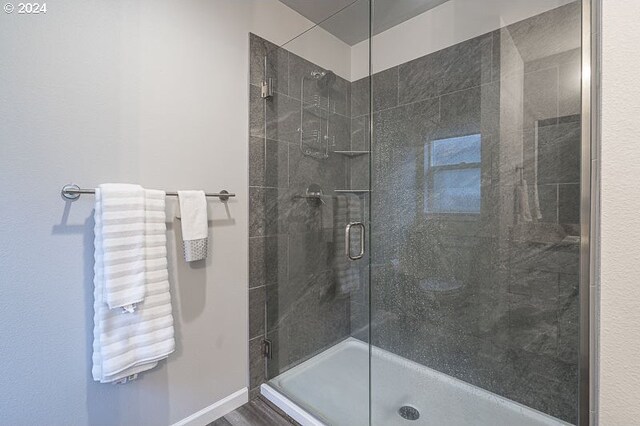 bathroom featuring a shower with door