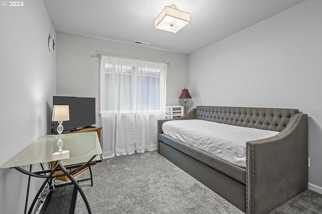 carpeted bedroom featuring visible vents