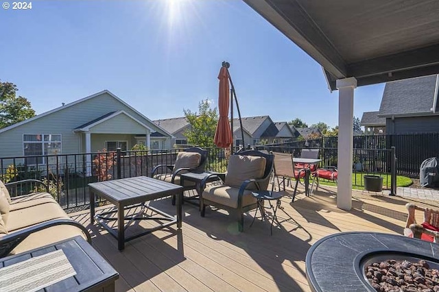 wooden terrace featuring an outdoor fire pit