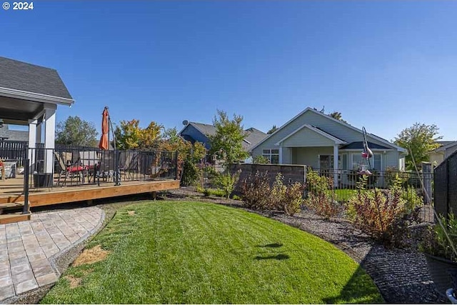 view of yard with fence and a deck